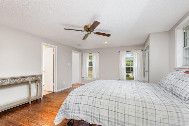 567 Peavy Rd, Dallas, TX 75218 - bedroom with wood finished floors, a textured ceiling, and a ceiling fan