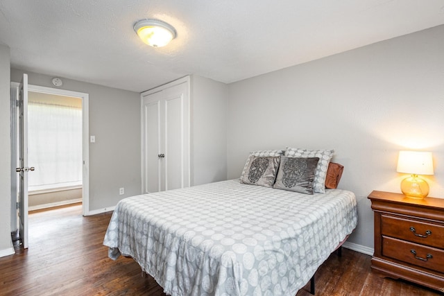 567 Peavy Rd, Dallas, TX 75218 - bedroom featuring dark wood finished floors and a closet