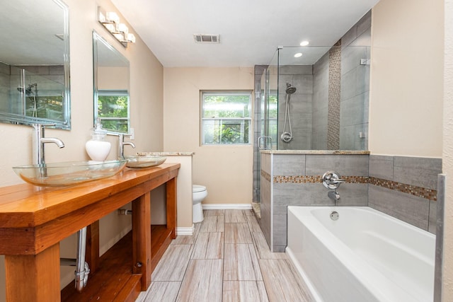 567 Peavy Rd, Dallas, TX 75218 - bathroom with a garden tub, a stall shower, and double vanity