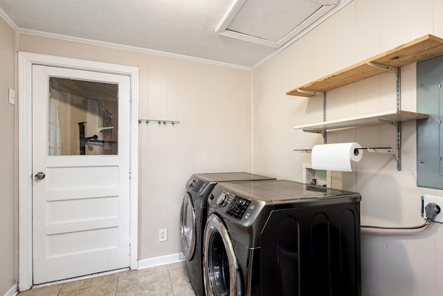 567 Peavy Rd, Dallas, TX 75218 - laundry room featuring washing machine and dryer, ornamental molding, and light tile patterned floors