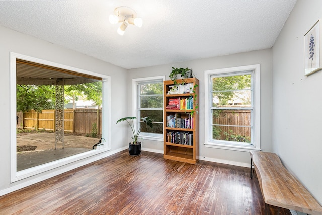 567 Peavy Rd, Dallas, TX 75218 - unfurnished room featuring wood finished floors, healthy amount of natural light, and a textured ceiling