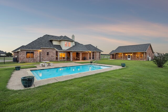 1535 Winding Creek Ln, Rockwall, TX 75032 - pool at dusk featuring a patio and an outdoor structure