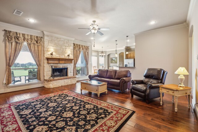 1535 Winding Creek Ln, Rockwall, TX 75032 - living area featuring a ceiling fan, ornamental molding, dark wood-type flooring, and a fireplace