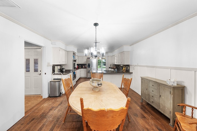 1440 Live Oak St, Sulphur Springs, TX 75482 - dining room with a chandelier, dark wood-style flooring, and crown molding