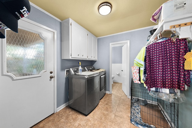 1440 Live Oak St, Sulphur Springs, TX 75482 - laundry area featuring washer and dryer, cabinet space, light tile patterned flooring, and ornamental molding