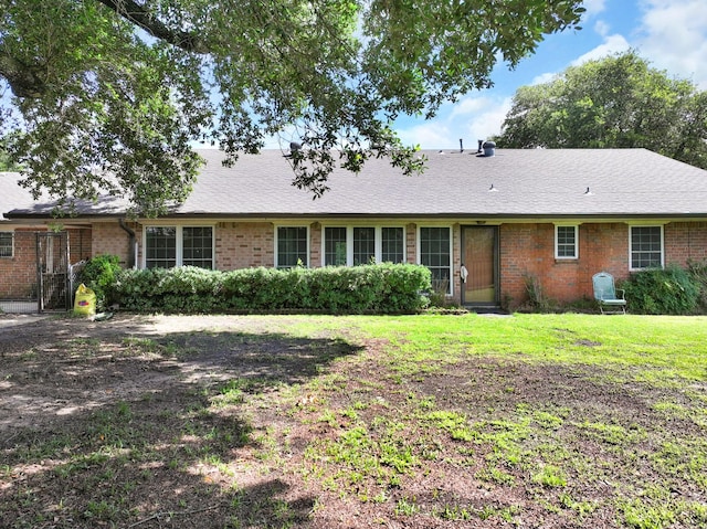 1440 Live Oak St, Sulphur Springs, TX 75482 - view of front of house featuring brick siding, a front yard, and a shingled roof