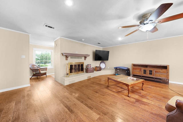 1440 Live Oak St, Sulphur Springs, TX 75482 - living room featuring wood-type flooring, ornamental molding, recessed lighting, a fireplace, and a ceiling fan