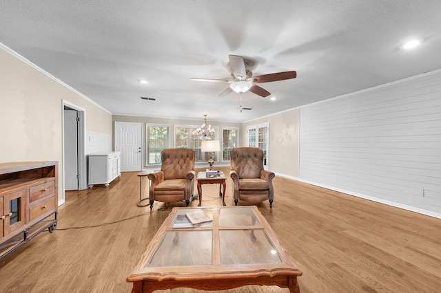 1440 Live Oak St, Sulphur Springs, TX 75482 - living room featuring a ceiling fan, ornamental molding, light wood-type flooring, wood walls, and recessed lighting
