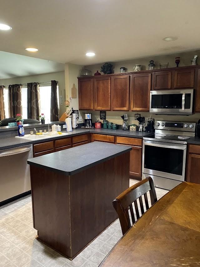 253 Pine Crest Dr, Justin, TX 76247 - kitchen with stainless steel appliances, dark countertops, recessed lighting, and a center island