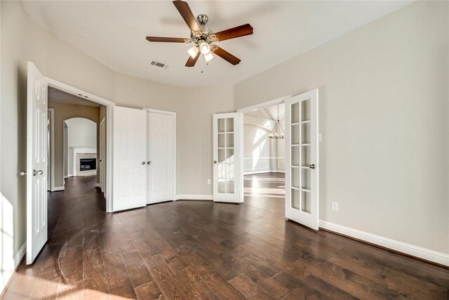 9204 Bottlebrush Ln, Irving, TX 75063 - spare room featuring french doors, wood finished floors, ceiling fan, and arched walkways
