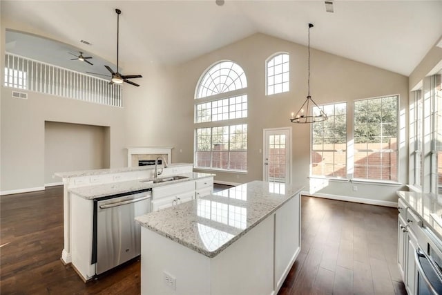9204 Bottlebrush Ln, Irving, TX 75063 - kitchen featuring an island with sink, dishwasher, high vaulted ceiling, a ceiling fan, and dark wood-style floors