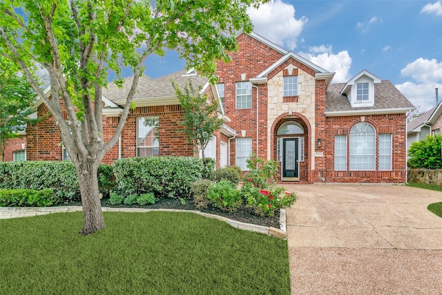 9204 Bottlebrush Ln, Irving, TX 75063 - view of front of home featuring brick siding, roof with shingles, concrete driveway, and a front yard