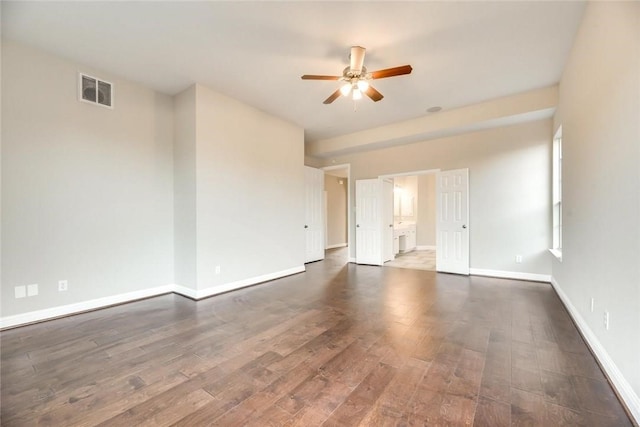 9204 Bottlebrush Ln, Irving, TX 75063 - spare room featuring ceiling fan and dark wood-style flooring