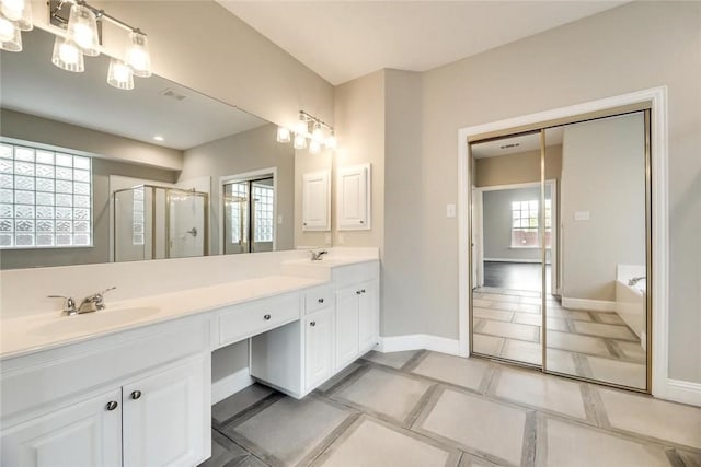 9204 Bottlebrush Ln, Irving, TX 75063 - full bath with a stall shower, double vanity, and a garden tub