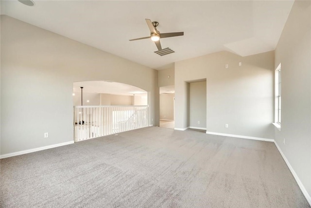 9204 Bottlebrush Ln, Irving, TX 75063 - carpeted empty room featuring ceiling fan, vaulted ceiling, and arched walkways