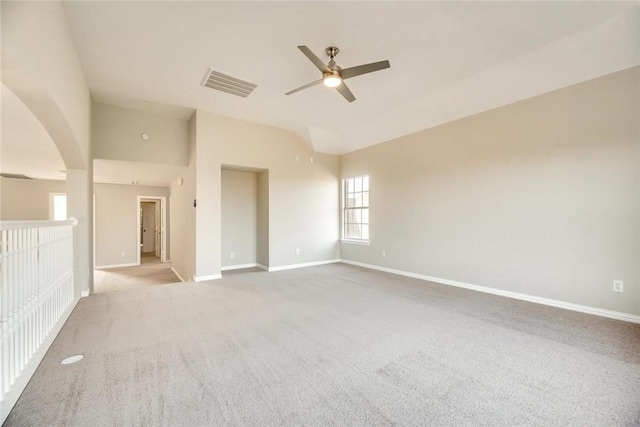 9204 Bottlebrush Ln, Irving, TX 75063 - carpeted empty room with a ceiling fan, arched walkways, and lofted ceiling