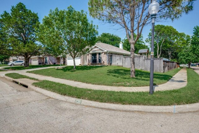 726 Texas Oak Trl, Lake Dallas, TX 75065 - view of front of house featuring an attached garage and concrete driveway