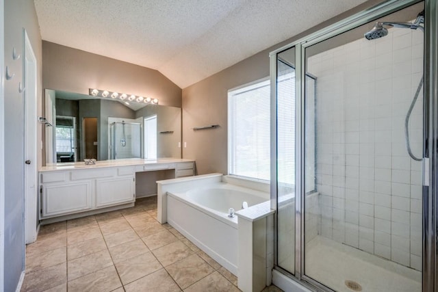 726 Texas Oak Trl, Lake Dallas, TX 75065 - bathroom featuring a shower stall, vanity, a bath, tile patterned floors, and vaulted ceiling
