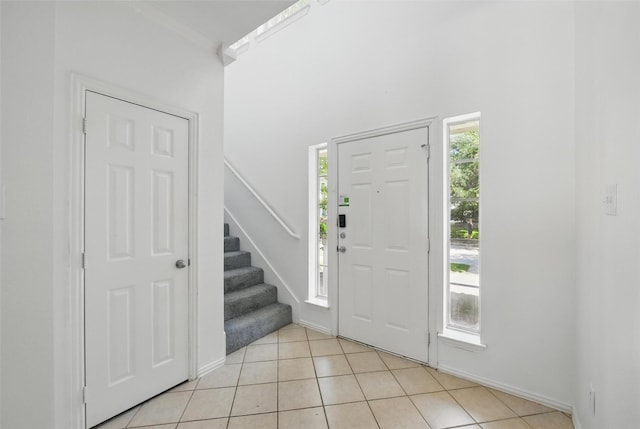 9846 Cedarcrest Dr, Providence Village, TX 76227 - foyer entrance featuring stairway, light tile patterned flooring, and a towering ceiling
