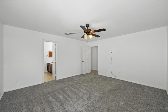 9846 Cedarcrest Dr, Providence Village, TX 76227 - unfurnished bedroom featuring light carpet, connected bathroom, and a ceiling fan