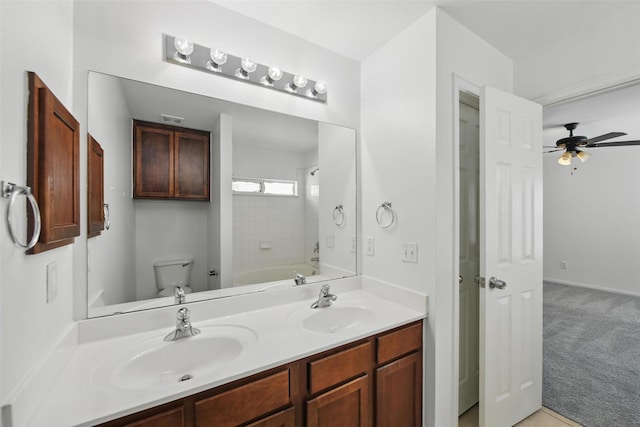 9846 Cedarcrest Dr, Providence Village, TX 76227 - bathroom featuring double vanity, ceiling fan, and tub / shower combination