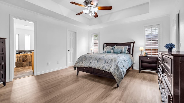 3705 Starlight Trl, Plano, TX 75023 - bedroom featuring a tray ceiling, light wood-type flooring, and ceiling fan