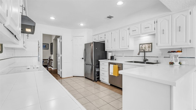3705 Starlight Trl, Plano, TX 75023 - kitchen featuring stainless steel appliances, white cabinetry, a peninsula, decorative backsplash, and recessed lighting