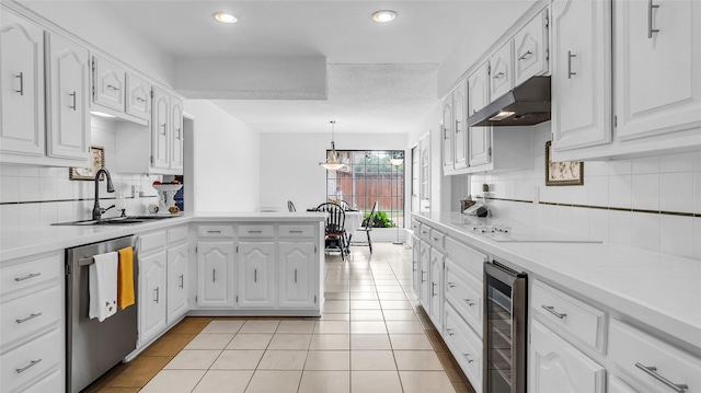 3705 Starlight Trl, Plano, TX 75023 - kitchen with wine cooler, stainless steel dishwasher, under cabinet range hood, a peninsula, and tasteful backsplash