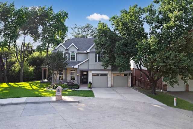 7955 Enclave Way, Dallas, TX 75218 - view of front of house featuring driveway, a front yard, a garage, stucco siding, and stone siding