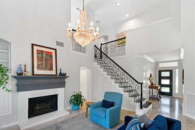 7955 Enclave Way, Dallas, TX 75218 - living area with a high ceiling, stairway, a chandelier, a brick fireplace, and arched walkways