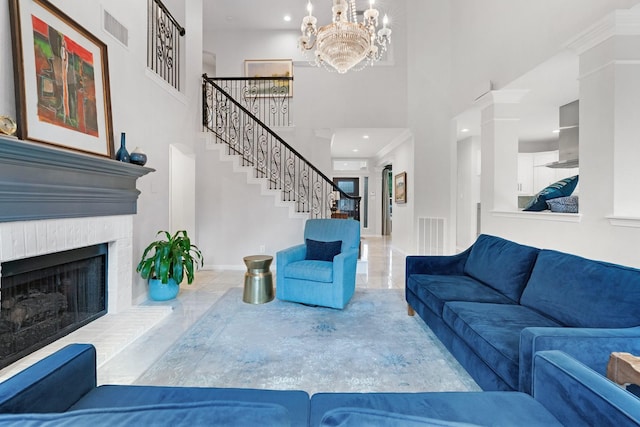 7955 Enclave Way, Dallas, TX 75218 - living area featuring a towering ceiling, stairway, a fireplace with raised hearth, and a chandelier