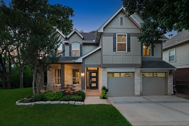 7955 Enclave Way, Dallas, TX 75218 - view of front of house with stone siding, concrete driveway, a garage, and a front lawn