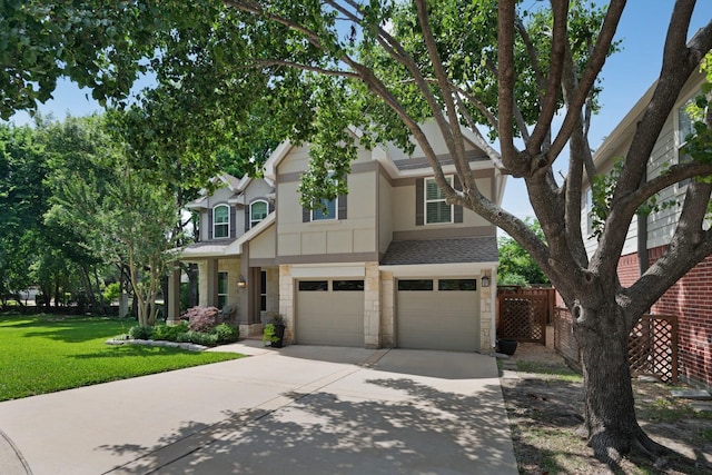7955 Enclave Way, Dallas, TX 75218 - view of front facade with stone siding, driveway, an attached garage, and a shingled roof