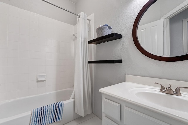7955 Enclave Way, Dallas, TX 75218 - bathroom featuring a textured wall, shower / bath combination with curtain, and vanity