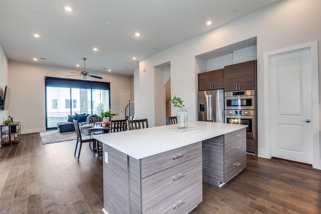 381 E Greenbriar Ln Unit 501, Dallas, TX 75203 - kitchen with stainless steel appliances, modern cabinets, dark wood finished floors, light countertops, and a center island