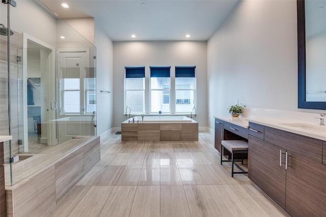 381 E Greenbriar Ln Unit 501, Dallas, TX 75203 - full bath featuring vanity, a bath, recessed lighting, healthy amount of natural light, and a shower with door