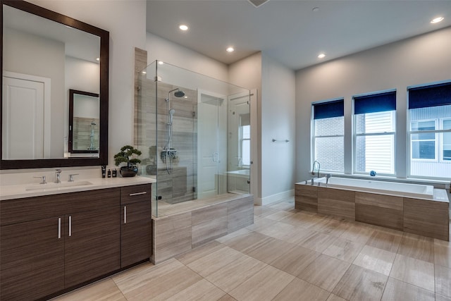 381 E Greenbriar Ln Unit 501, Dallas, TX 75203 - bathroom featuring vanity, a bath, a shower stall, tile patterned flooring, and recessed lighting