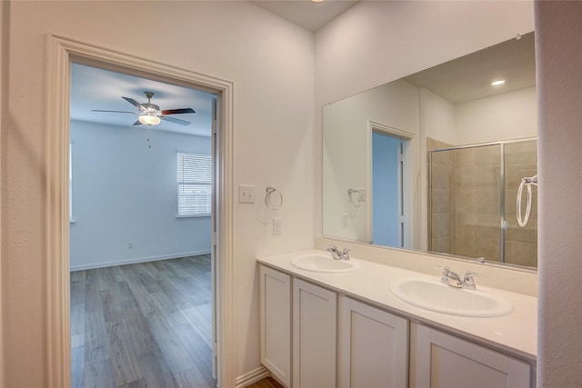 5221 Rockrose Ln, Princeton, TX 75407 - full bathroom featuring double vanity, a ceiling fan, a tile shower, and wood finished floors