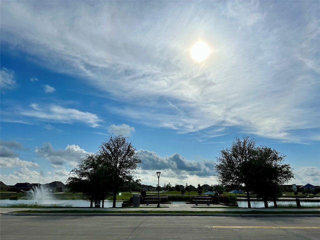 5221 Rockrose Ln, Princeton, TX 75407 - view of street featuring curbs, a water view, street lights, and sidewalks