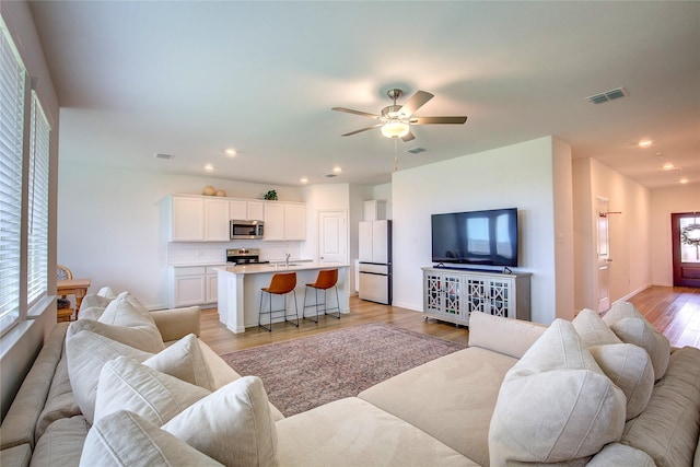 5221 Rockrose Ln, Princeton, TX 75407 - living area featuring light wood-type flooring, ceiling fan, and recessed lighting