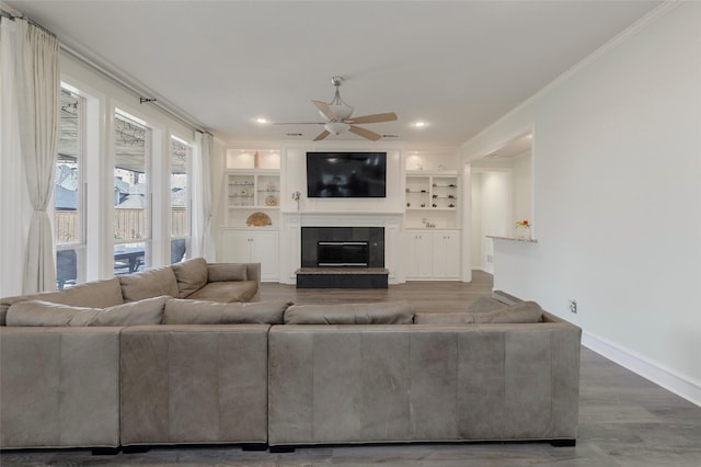 5729 Ridgehaven Dr, Plano, TX 75093 - living room featuring crown molding, ceiling fan, a tile fireplace, wood finished floors, and recessed lighting