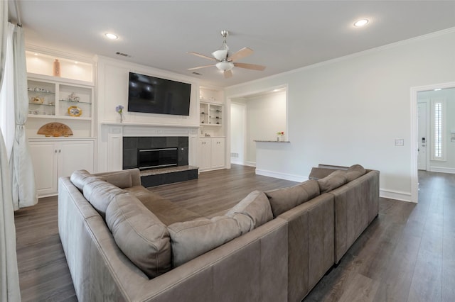5729 Ridgehaven Dr, Plano, TX 75093 - living room featuring a ceiling fan, ornamental molding, dark wood-style flooring, a tile fireplace, and recessed lighting