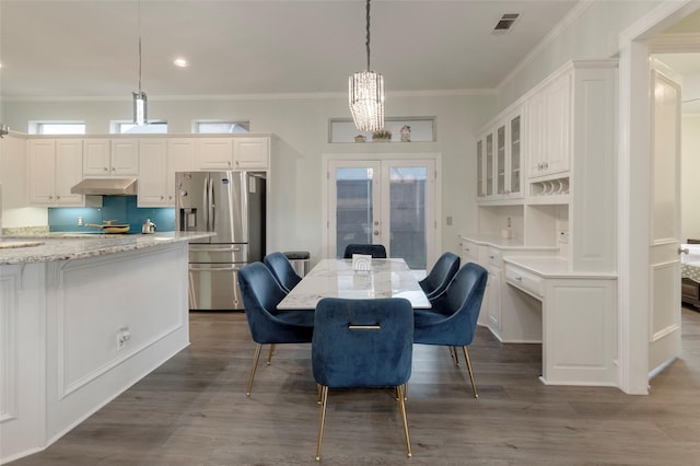 5729 Ridgehaven Dr, Plano, TX 75093 - dining room featuring french doors, crown molding, wood finished floors, recessed lighting, and a chandelier