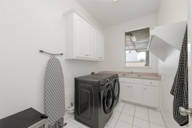 5729 Ridgehaven Dr, Plano, TX 75093 - washroom with cabinet space, washing machine and clothes dryer, and light tile patterned flooring