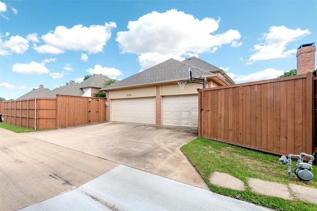 5729 Ridgehaven Dr, Plano, TX 75093 - view of side of property with a gate, concrete driveway, a garage, and roof with shingles