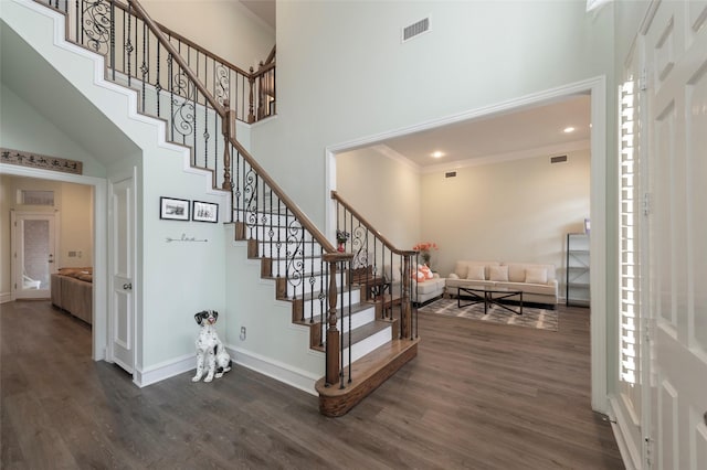 5729 Ridgehaven Dr, Plano, TX 75093 - stairway with a towering ceiling, wood finished floors, ornamental molding, and recessed lighting