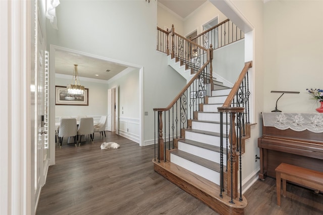 5729 Ridgehaven Dr, Plano, TX 75093 - stairway with ornamental molding, wood finished floors, and a chandelier