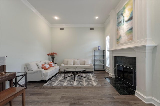 5729 Ridgehaven Dr, Plano, TX 75093 - living area with crown molding, wood finished floors, a high end fireplace, and recessed lighting