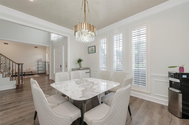 5729 Ridgehaven Dr, Plano, TX 75093 - dining area featuring stairway, a chandelier, dark wood-style flooring, and crown molding