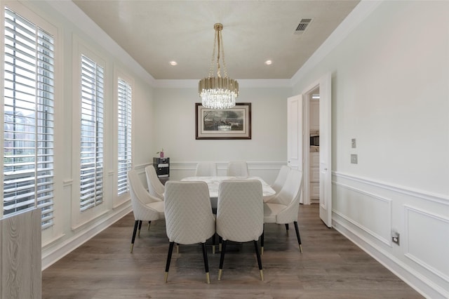 5729 Ridgehaven Dr, Plano, TX 75093 - dining room featuring a chandelier, a decorative wall, crown molding, wainscoting, and wood finished floors